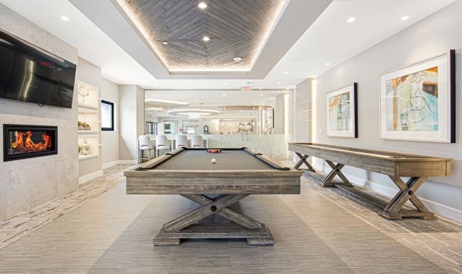 a large room with a fireplace and a pool table
