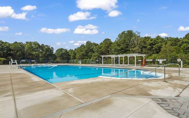 a swimming pool with trees in the background