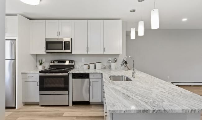 a kitchen with white cabinets